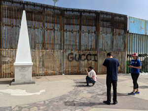 NU students taking pictures at US/Mexico border wall. View 1